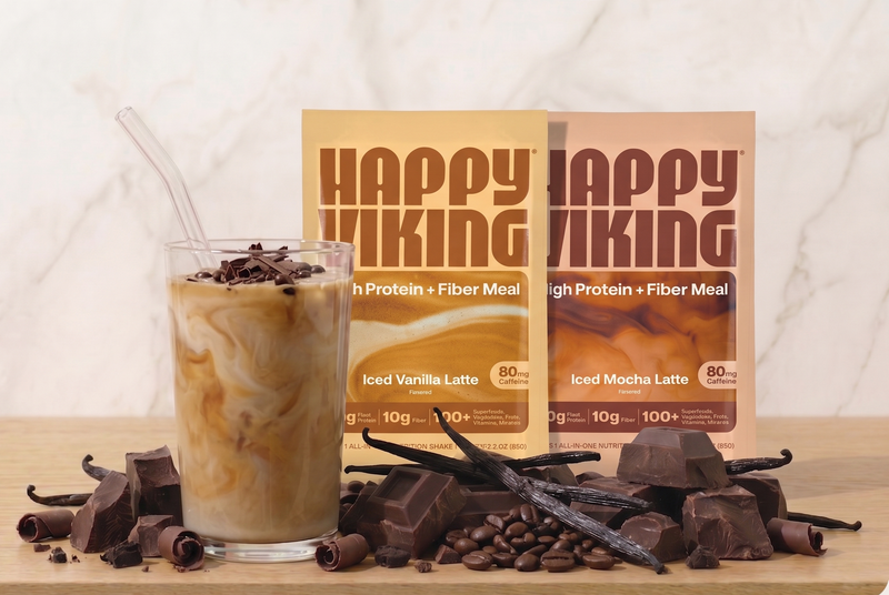 Happy Viking protein meal replacement shake with packaging and ingredients on a wooden surface.